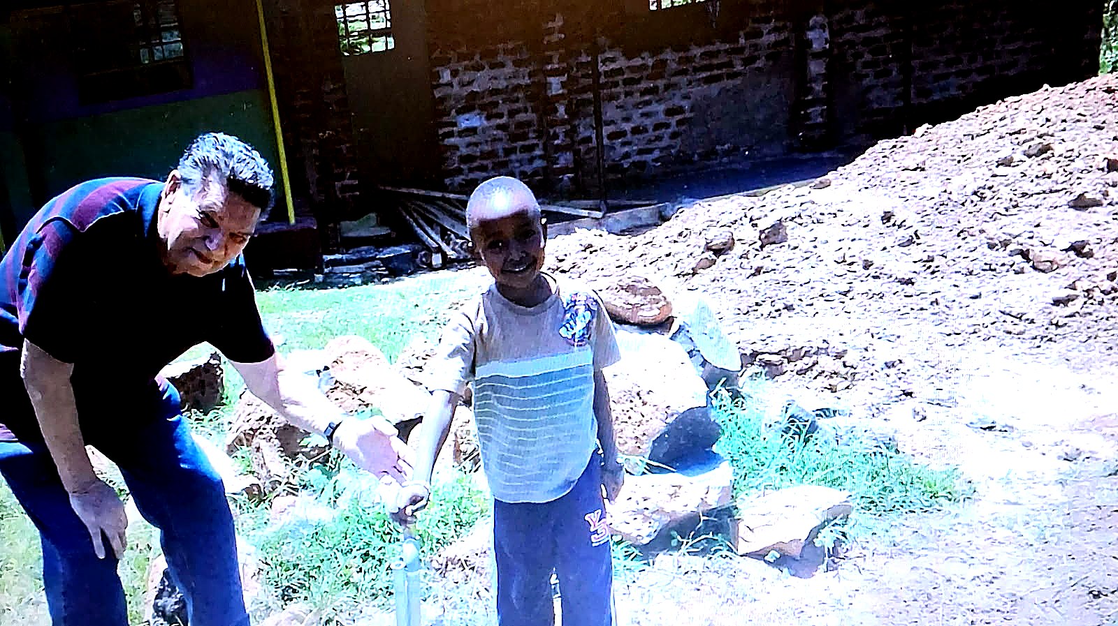 A child receiving water from a newly built tap